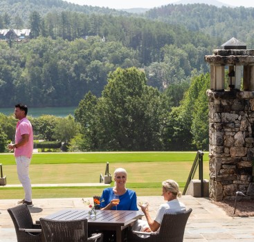 a group of people sitting at a table on a patio