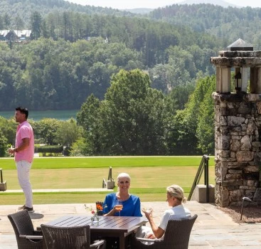 a group of people sitting at a table on a patio