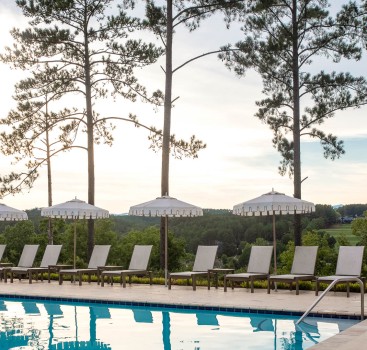 a pool with umbrellas and chairs