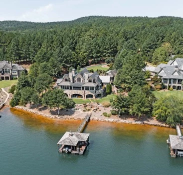 a large house with a dock on the water