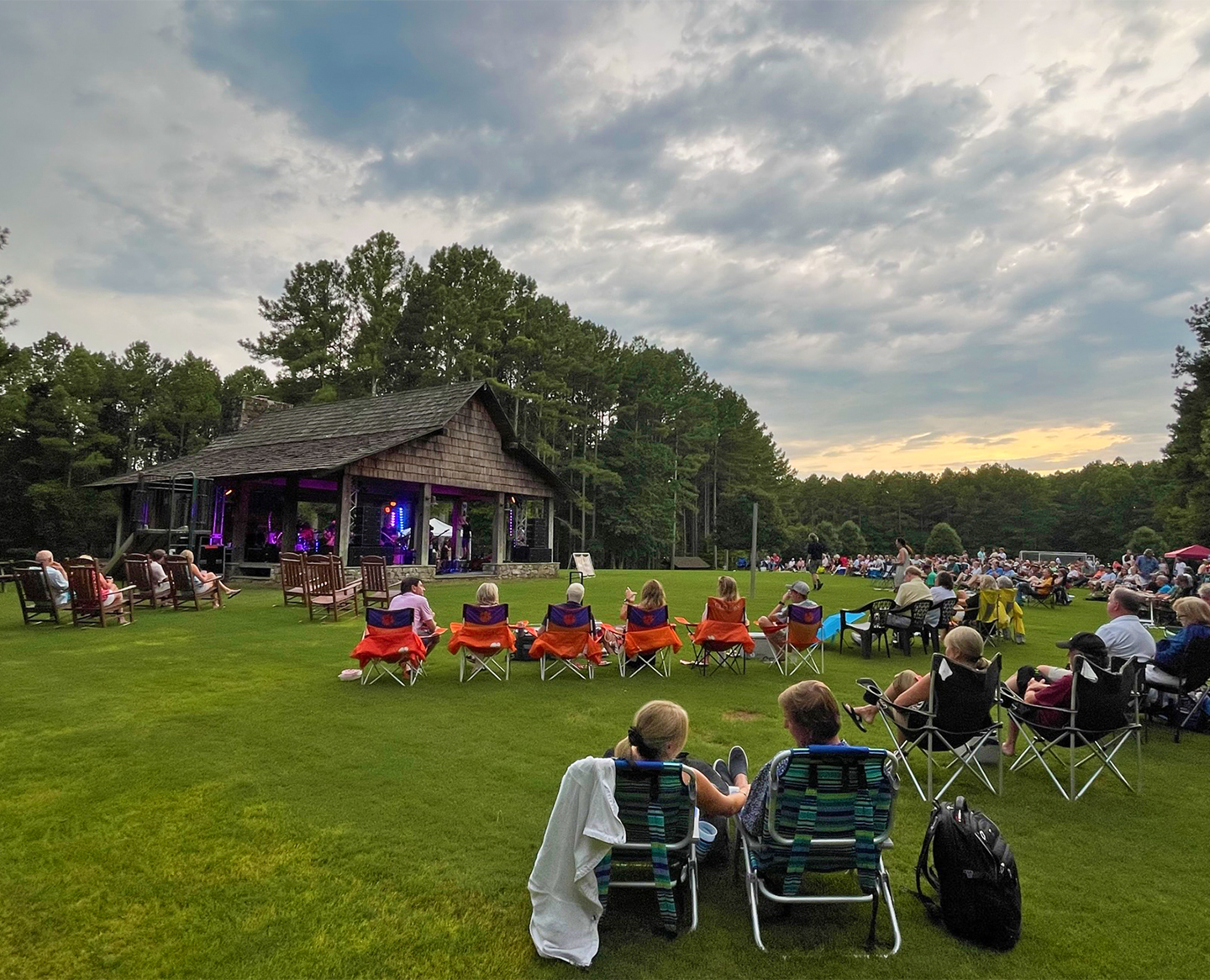a group of people sitting in lawn chairs in front of a building