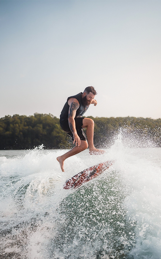 a man riding a surfboard on a wave