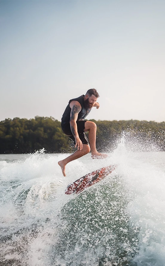 a man riding a surfboard on a wave