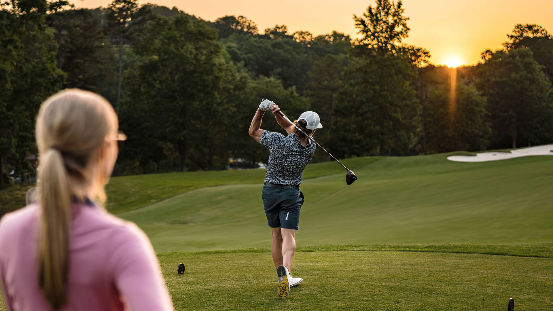 a man swinging a golf club