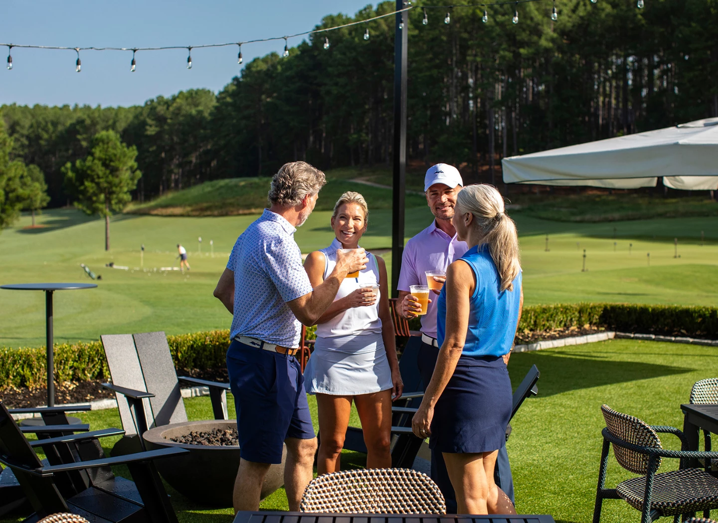 a group of people standing around a fire pit