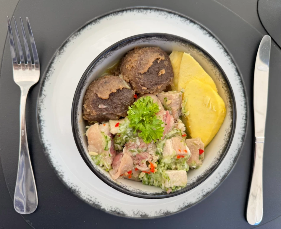 a bowl of food with a fork and knife