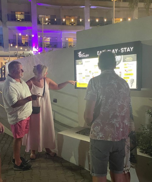 a group of people standing around a sign