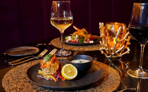 a plate of food and a glass of wine