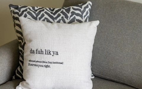 a white pillow with black text on it