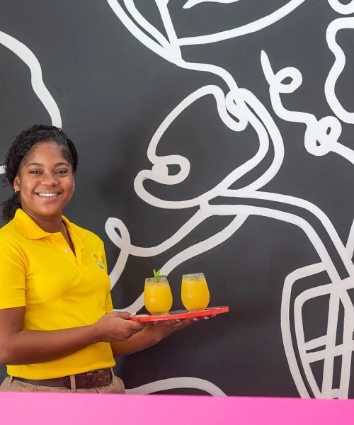 a woman holding a tray of drinks
