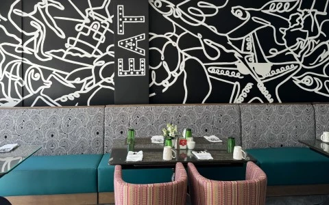 a table with chairs and a painting on the wall