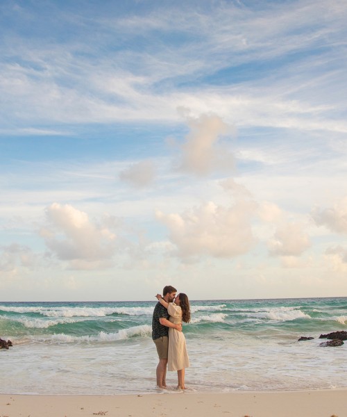 a man and woman standing on a beach
