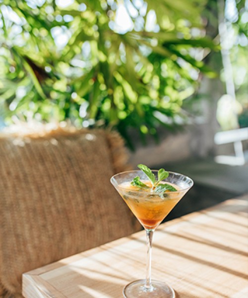 a glass of orange drink on a table