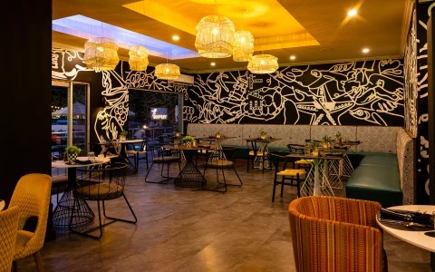 a room with tables and chairs and a wall with lights