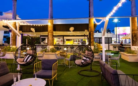 a patio with chairs and tables and a bar