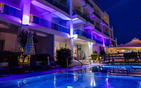 a building with a pool and purple lights