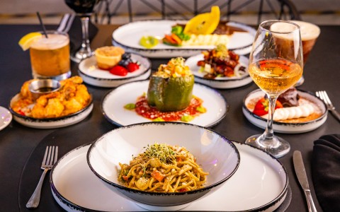 a table with plates of food and drinks