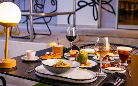 a table with plates of food and drinks