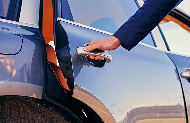 a person opening a car door