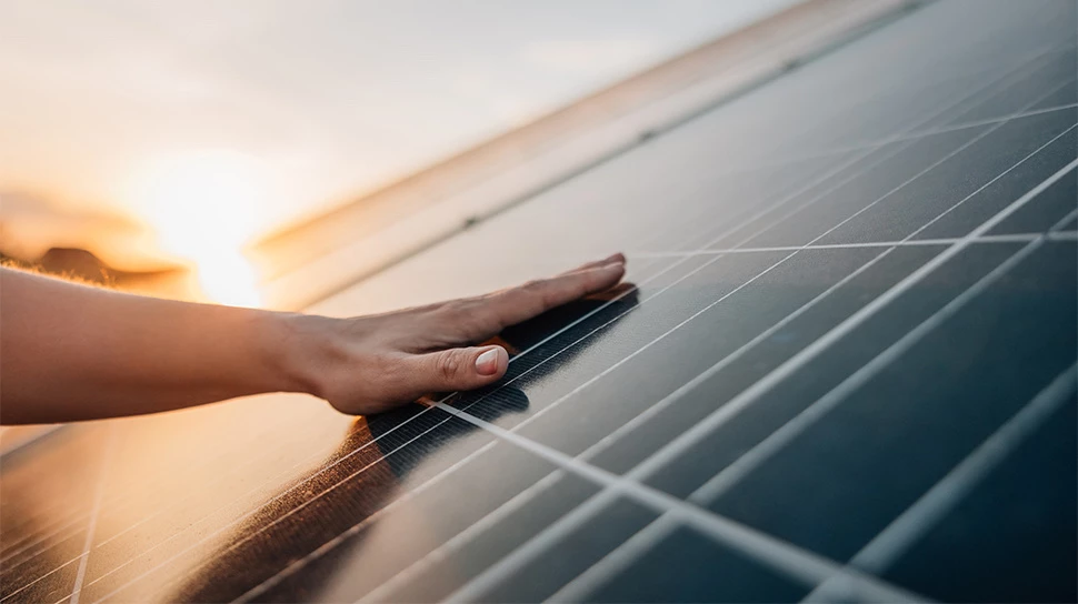 a person touching a solar panel