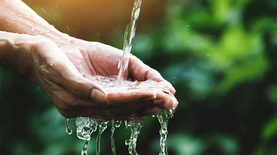 a person pouring water into their hand