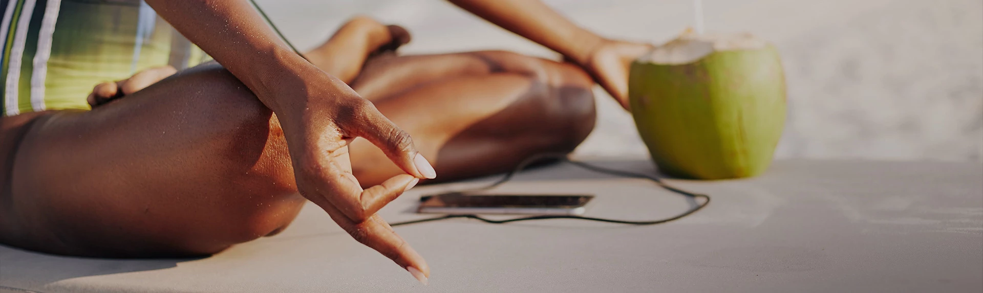 close up view of a woman meditating while holding a coconut