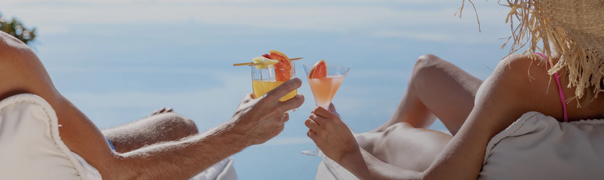 two people clinking their cocktails