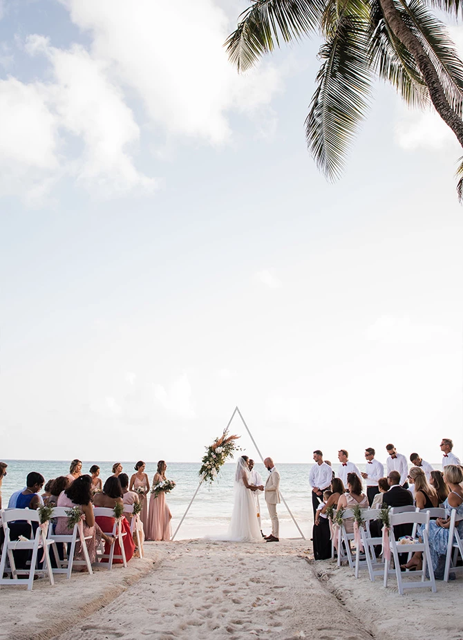 a group of people at a beach wedding