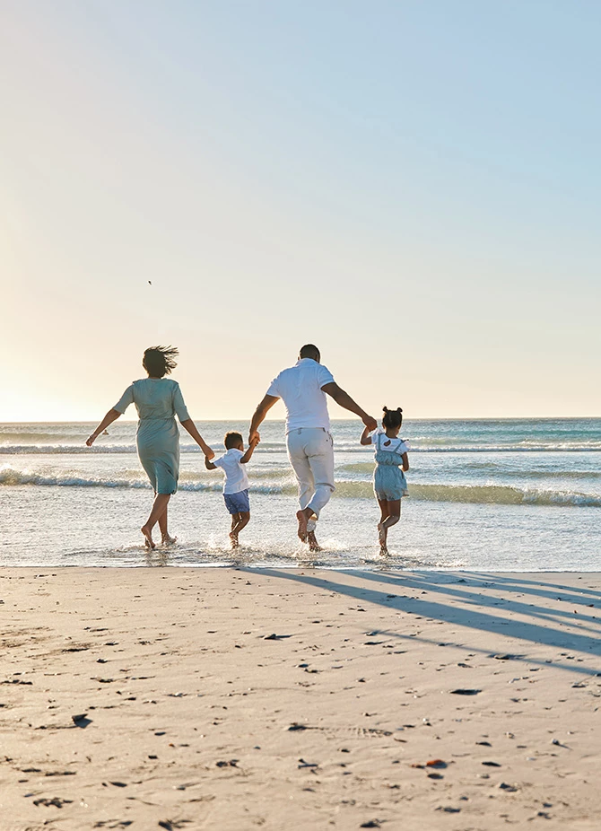 a family running on a beach