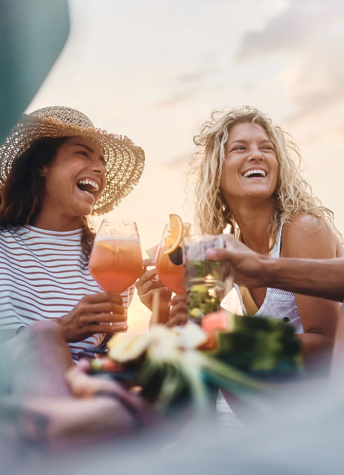 a group of women laughing and drinking
