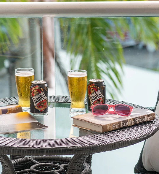 a table with glasses of beer and a book on it
