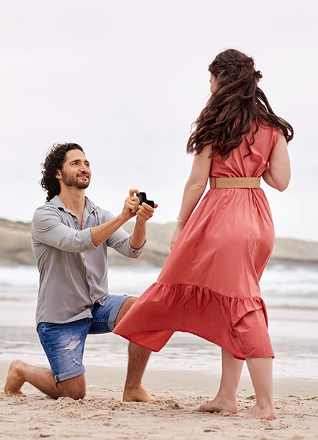 a man proposing to a woman on the beach