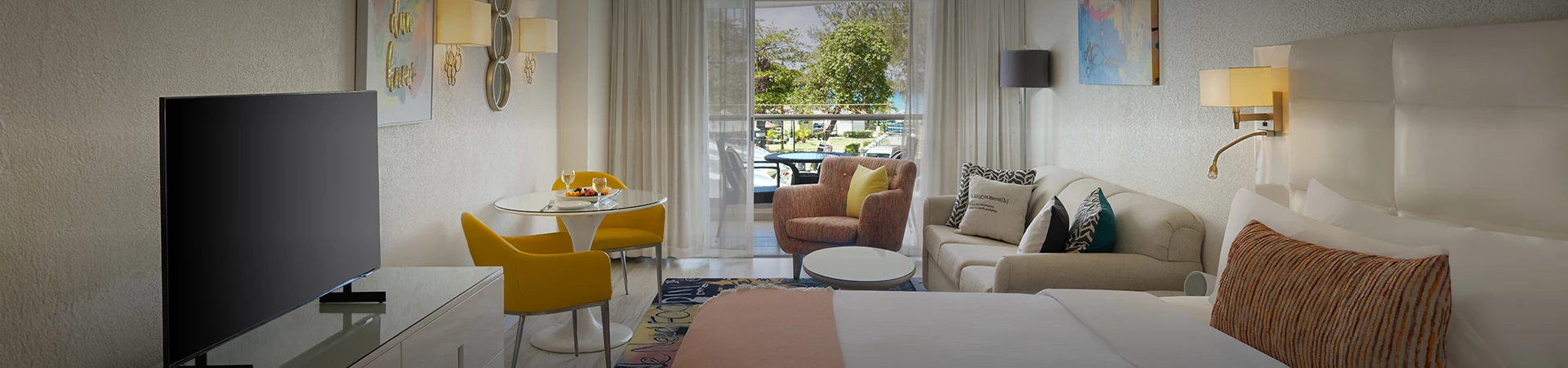 a room with a bed and chairs