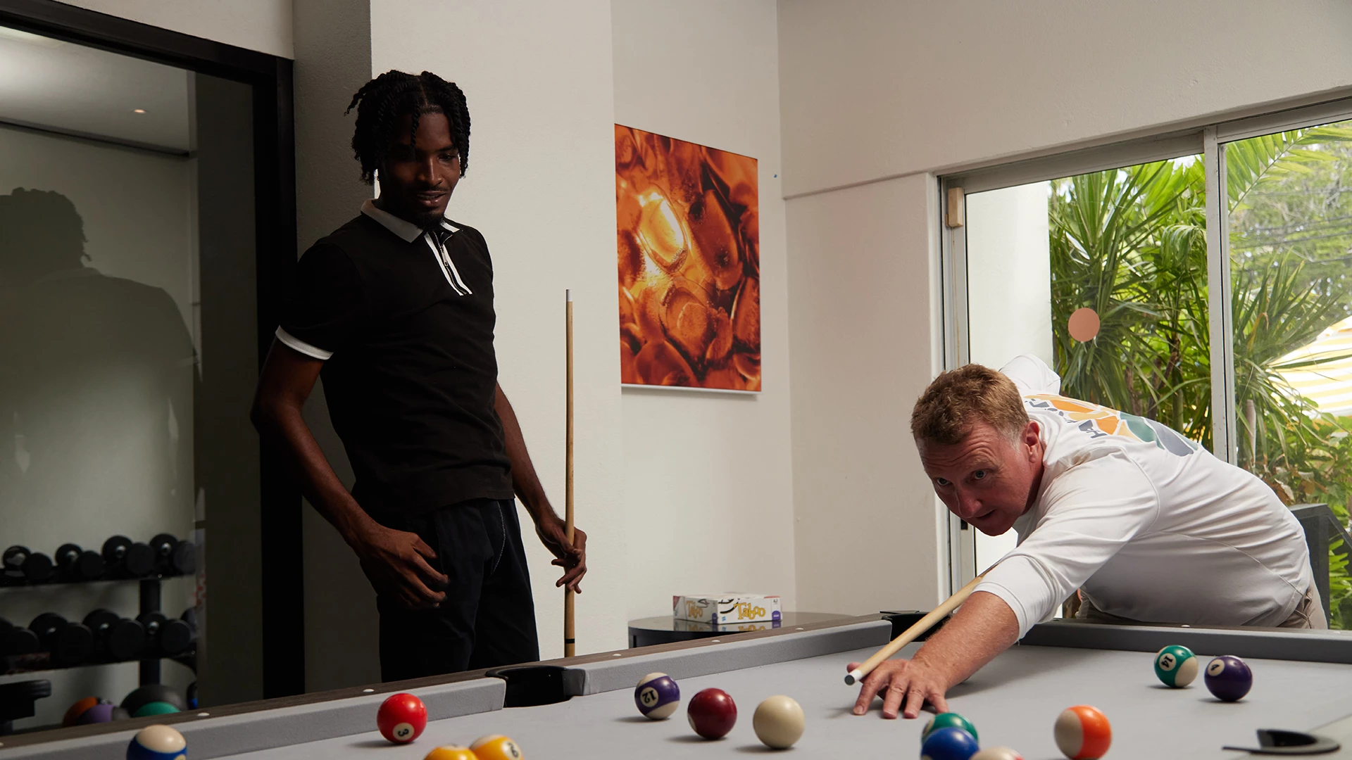 a man playing pool with a stick