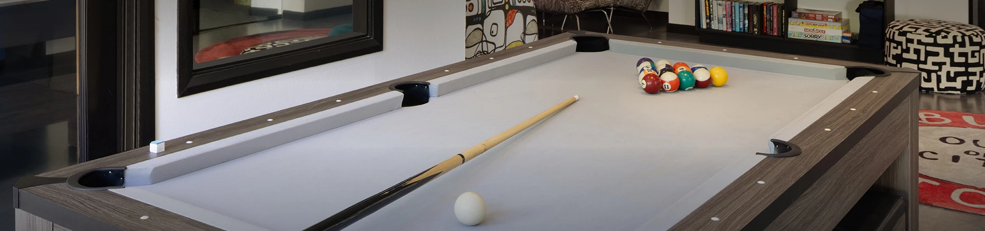 a pool table with a cue stick and a ball