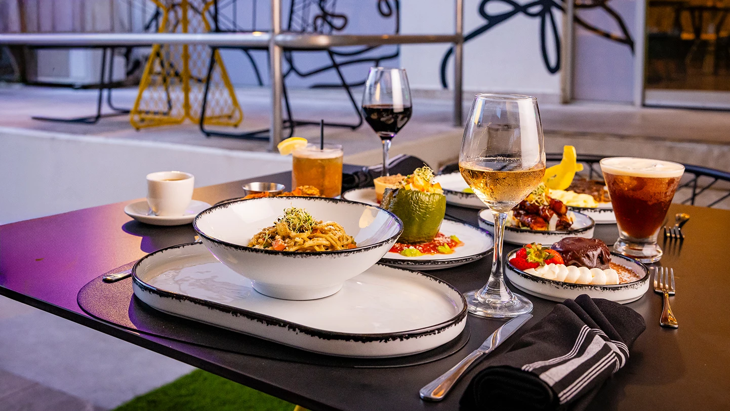 a table with plates of food and drinks
