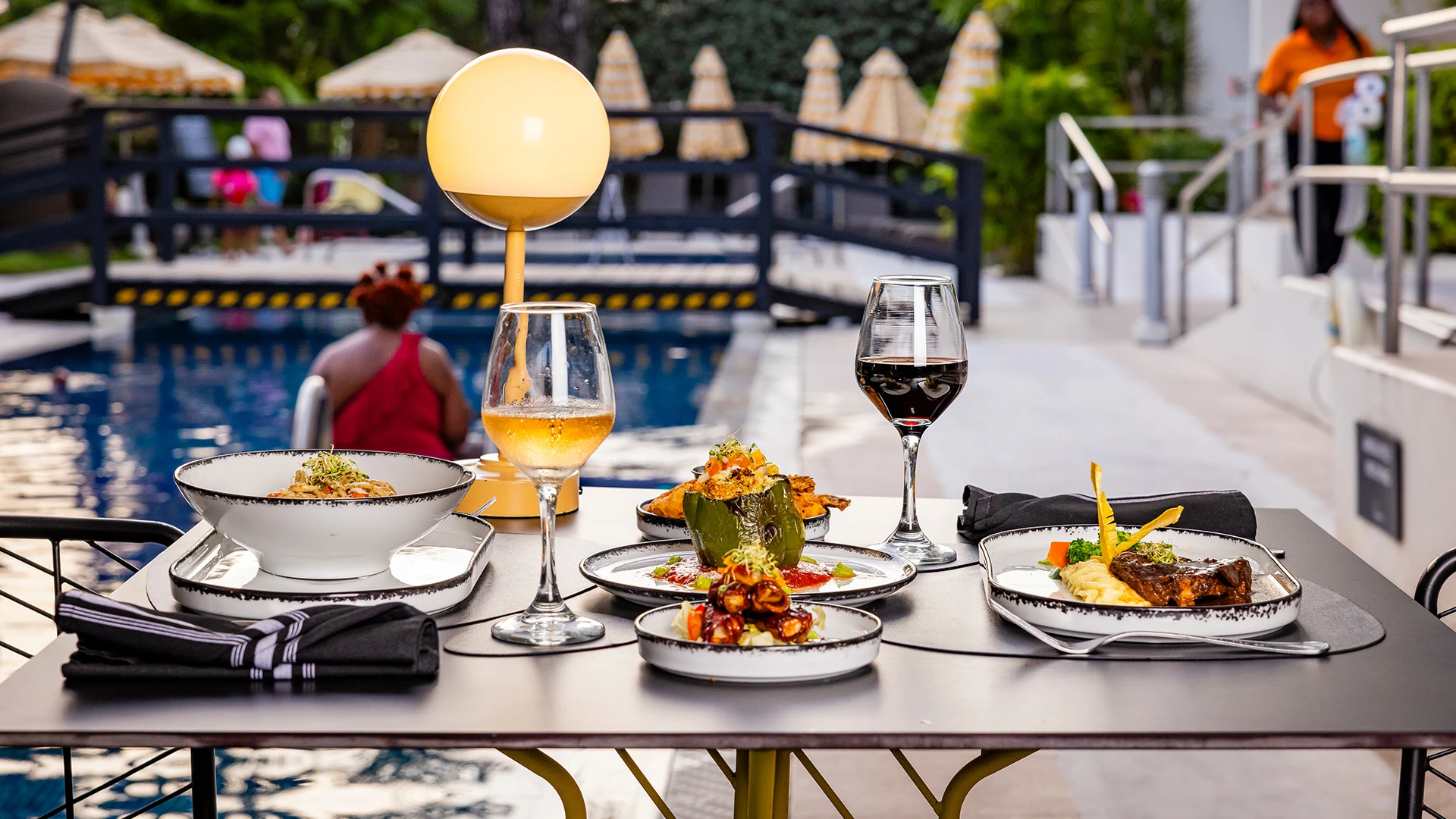 a table with plates of food and wine glasses on it