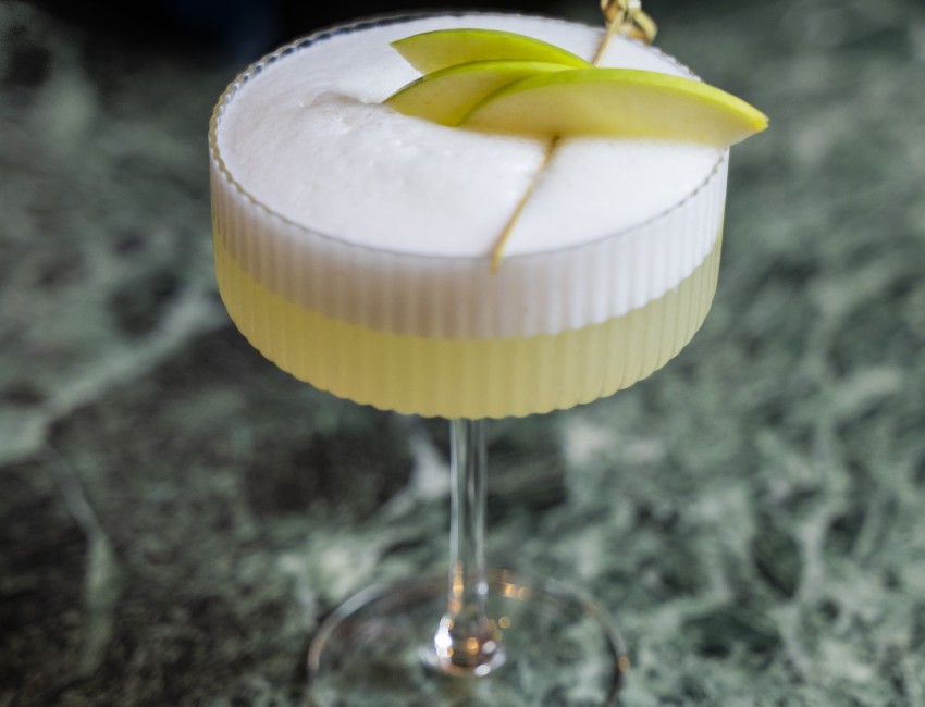 a glass with a drink on it