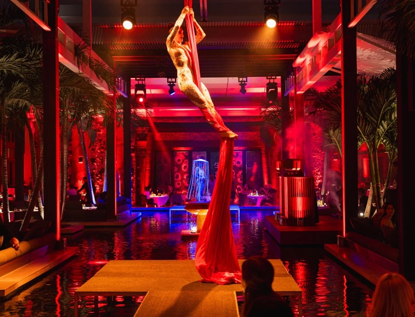 a person from a rope in a room with red lights