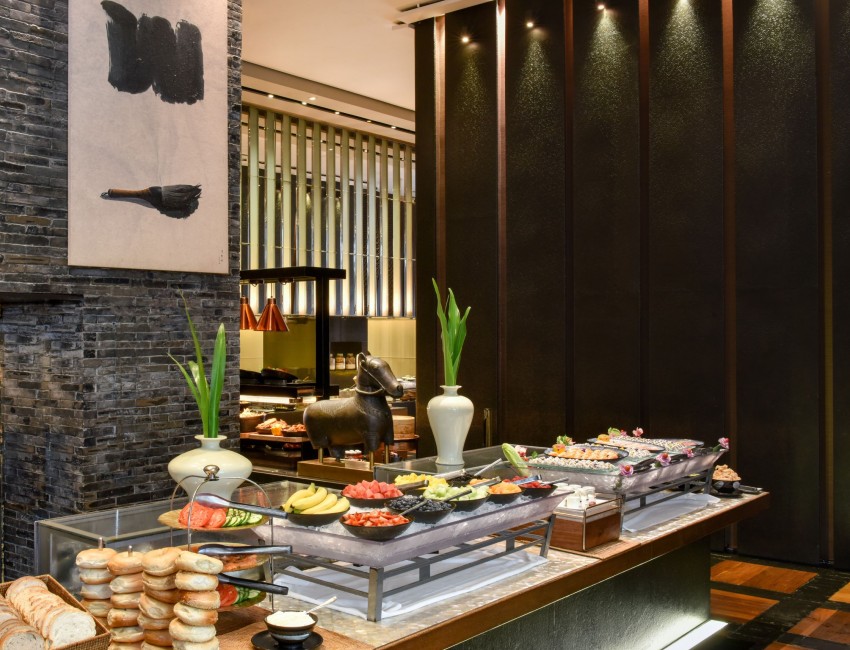 breakfast buffet with fresh fruits, breads and sushi