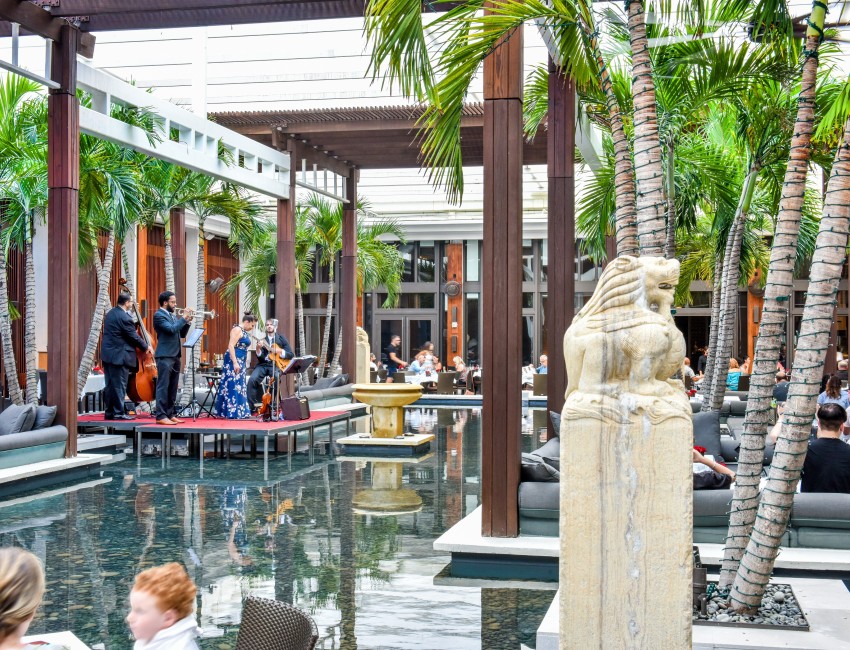 a group of people playing instruments in a pool