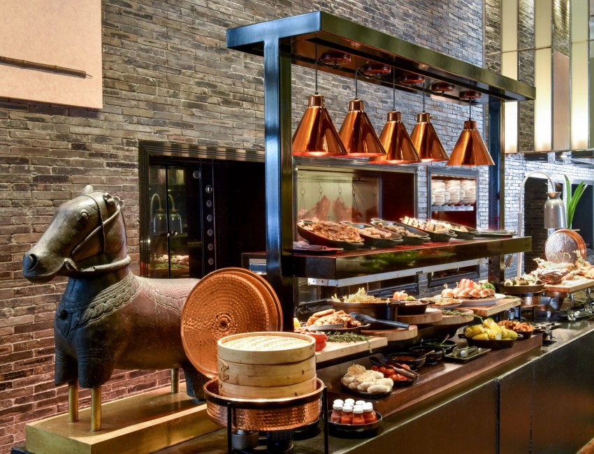 brunch buffet displaying eggs, meats, dim sum and more
