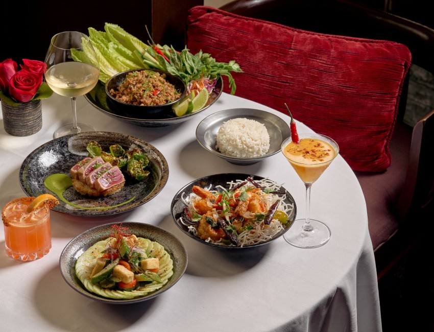 a table with plates of food and drinks