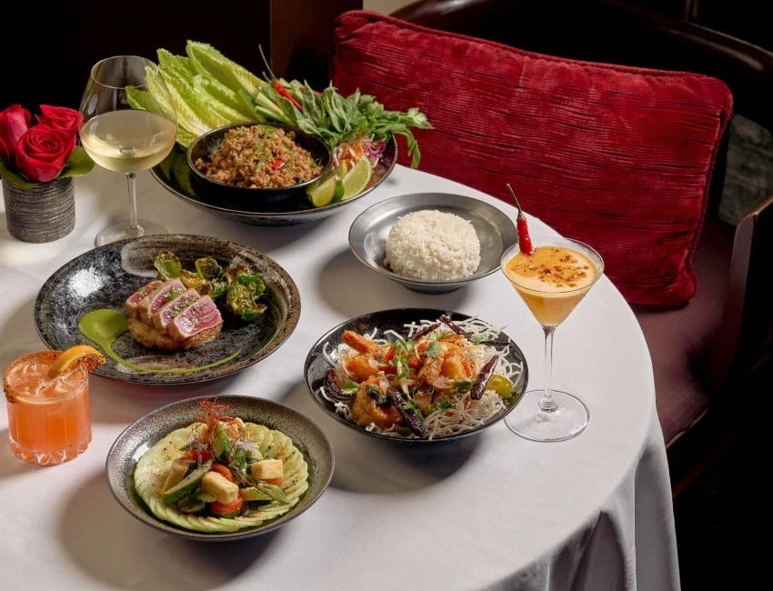 a table with plates of food and drinks