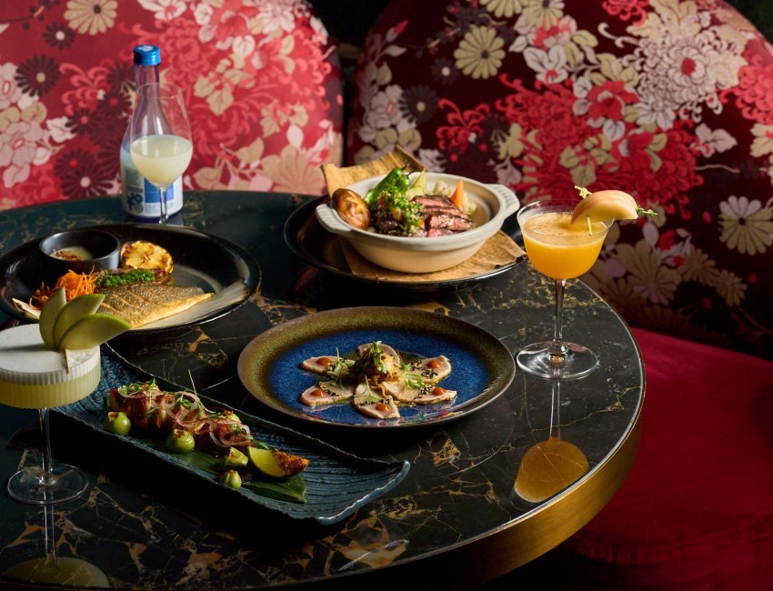 a table with plates of food and drinks