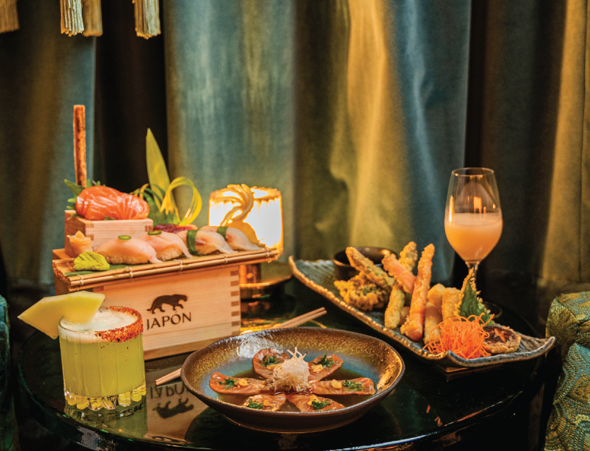 a table with plates of food and drinks