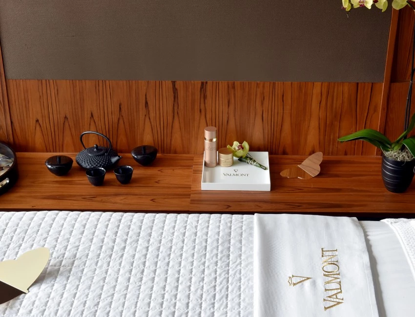 an area set up for a spa service with small candles and a black tea kettle