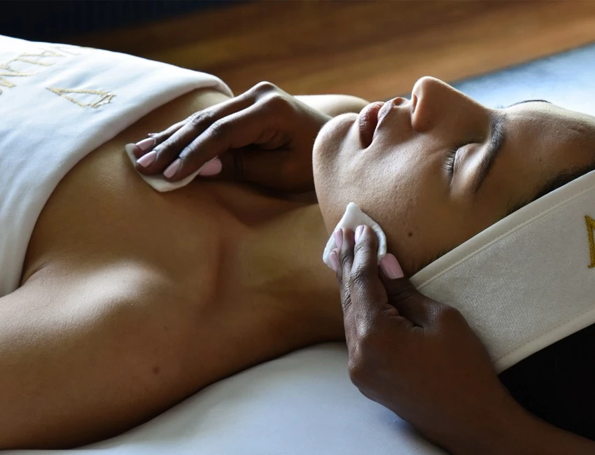 a person giving a woman a facial