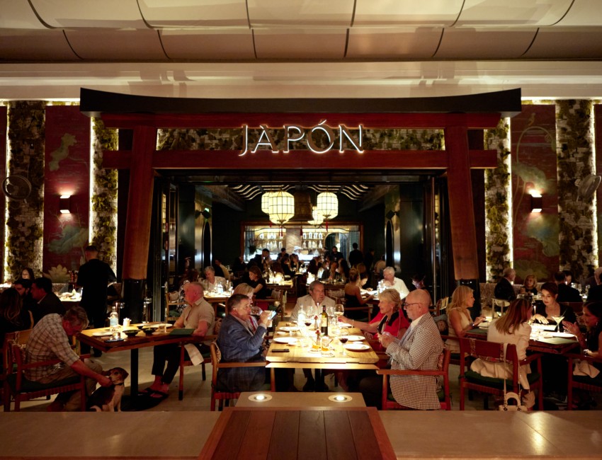 a group of people sitting at tables in a restaurant