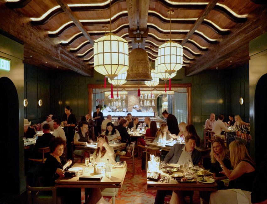 a group of people sitting at tables in a restaurant